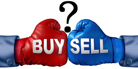 Buy or sell stocks or shares in a business as a boxing match in the symbolic financial ring of investing with two gloves fighting for trading direction in the stock market isolated on a white background.